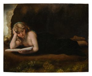 Aa woman laying on the ground reading a bookDescription automatically generated with low confidence
