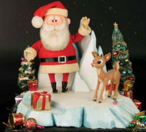 Santa Claus and Rudolph the red nosed reindeer standing on snow with presents