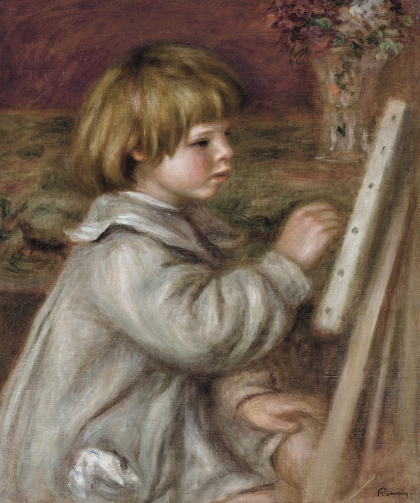 young boy painitng at an easle
