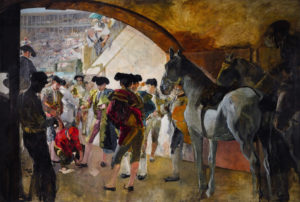 men and horses standing in a tunnel