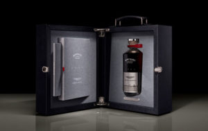 Bottle of Black Bowmore whiskey in presentation case with Aston Martin DB5 piston on bottle