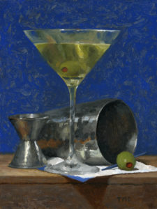 a martini with a shaker and olives