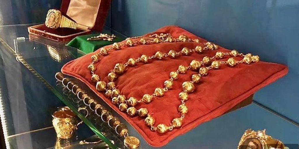 rosary beads on a red pillow