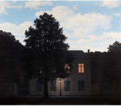 A suburban house among trees with a lamppost in the dark with a blue, cloudy, midday sky above