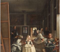 A group of young girls in wide seventeenth-century dresses and skirts. Off to the left, the artist has painted himself peering out from behind a canvas and an easel with a paintbrush and a palette. On the far wall, a mirror shows that you are seeing this from the view of the King and Queen of Spain sitting for their portrait while your daughter and her handmaidens look on.
