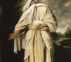 A portrait of a tan-skinned man in billowing white robes and a turban.