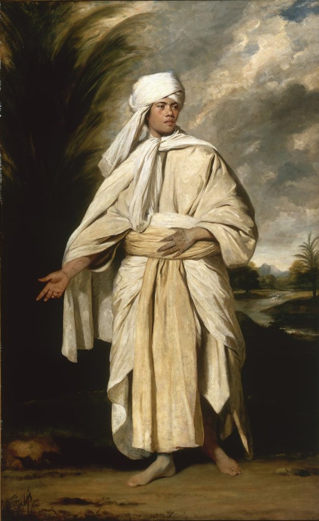 A portrait of a tan-skinned man in billowing white robes and a turban.