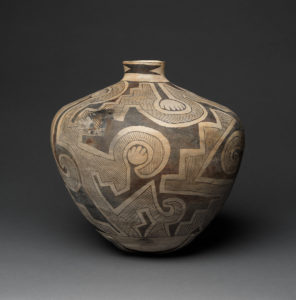 A clay jar with an abstract Indigenous Pueblo design in black and white.