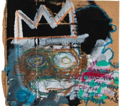 An abstract, grafitti-like portrait showing a crowned head against a black background on a piece of cardboard
