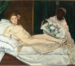 A nude woman reclining on her bed with a servant woman giving her a gift of flowers to the right. A black cat stands by her feet.