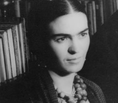 A black-and-white photograph of Frida Kahlo