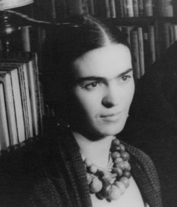 A black-and-white photograph of Frida Kahlo