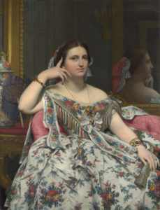 A portrait by Ingres of a woman in a nineteenth-century dress sitting on a red sofa.