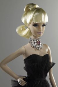 Barbie Doll with blond hair in pony tail and black strapless dress with white and pink diamond necklace