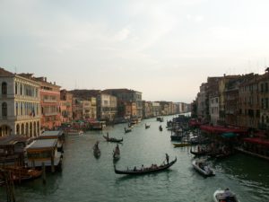 A view over the Grand Canal in Venice, with small boats and gondolas making their way to and fro