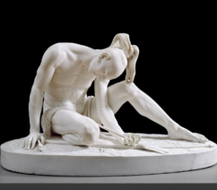 A marble sculpture of an indigenous man collapsed on the ground after having pulled out an arrow shot in his side.