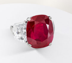 A large ruby set in a platinum ring supported by diamonds