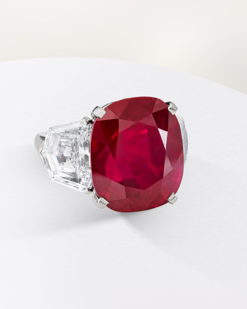 A large ruby set in a platinum ring supported by diamonds
