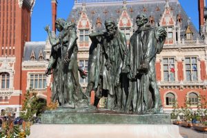 A bronze statue in a public square in Calais showing six male figures with ropes around their necks, created by Auguste Rodin