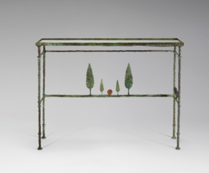 A bronze and iron console table decorated by metal tree sculptures on the crossbar.