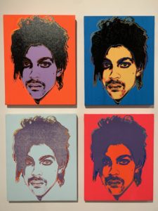 Four silkscreen prints in different colors showing portraits of the singer and musician Prince.