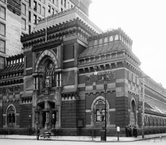 A black-and-white photograph of a large brick building.