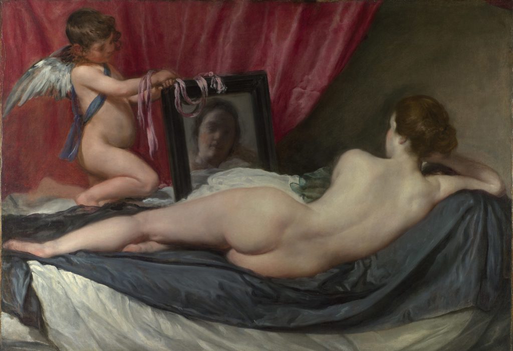 A painting of Venus laying nude with her back to the viewer while Cupid holds up a mirror.