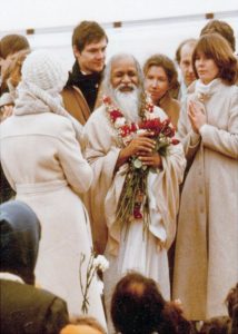 Maharishi Mahesh Yogi receiving flowers during a visit to Iowa