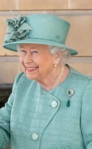 Queen Elizabeth II in a teal dress and hat