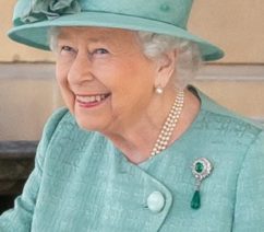 Queen Elizabeth II in a teal dress and hat