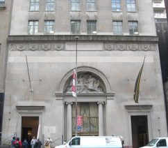 The façade of Steinway Hall, with neoclassical columns and sculptures surrounding the front door.
