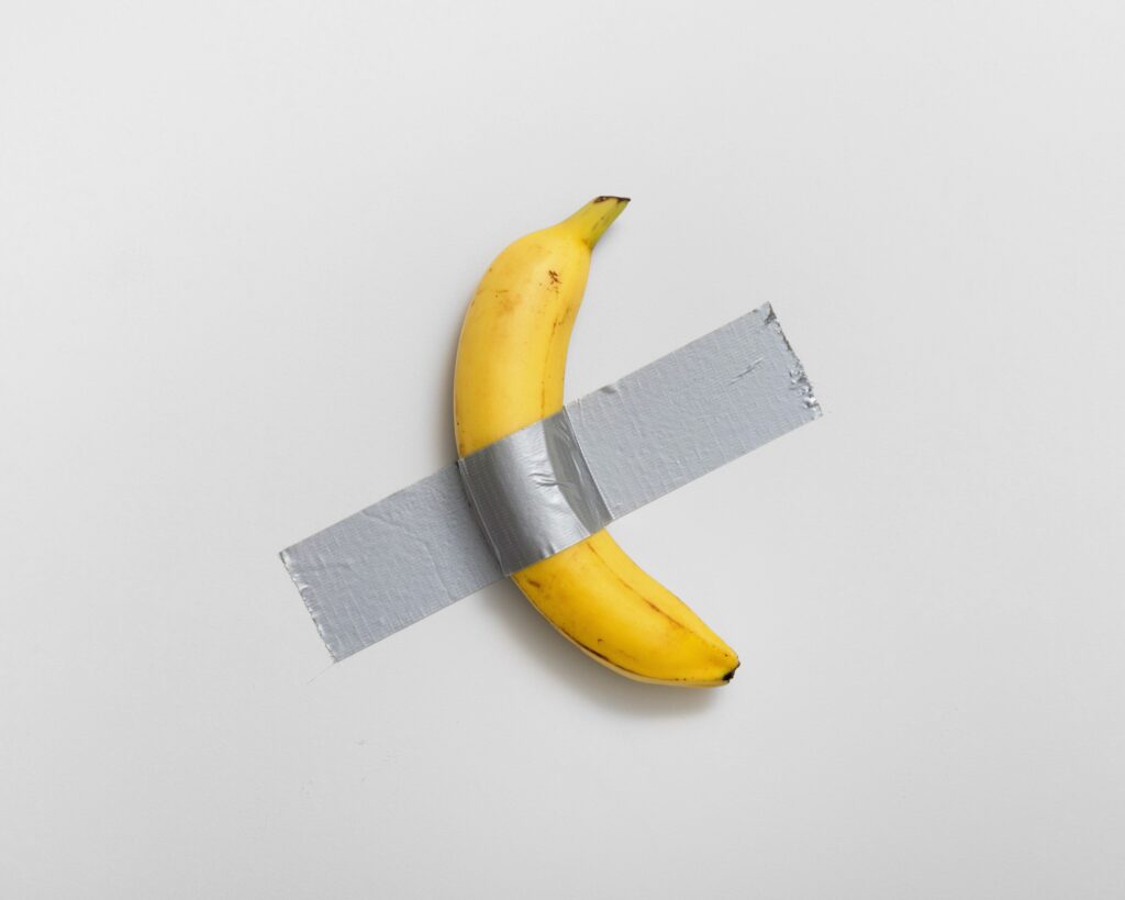 A banana duct taped to a wall