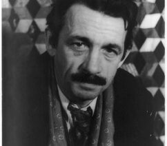 A black-and-white photograph of the painter Thomas Hart Benton, a middle-aged man with a thick moustache.