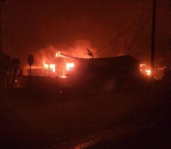 A photograph of a house on fire at night
