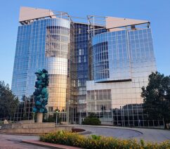 A large building covered with reflective windows.