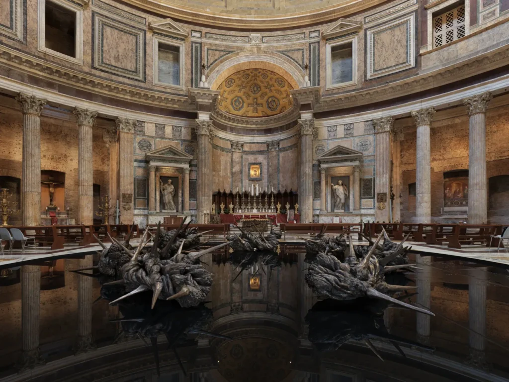 A large bronze sculpture in the shape of a broken crown of thorns.
