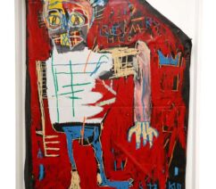 A painting by Basquiat of a man in a white shirt and jeans against a red background.