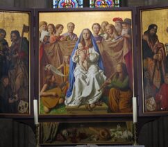 A religious triptych painting with a Madonna & Child in the center
