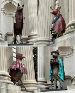 Four animal sculptures in niches on the facade of the Metropolitan Museum.