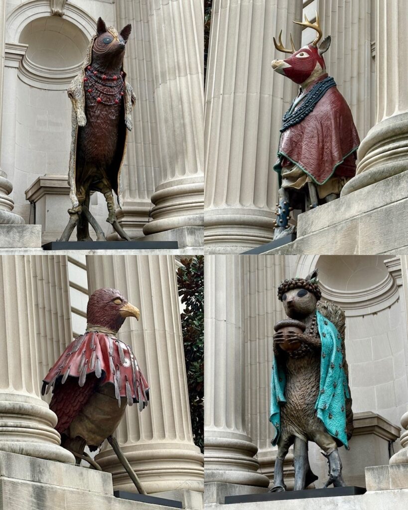 Four animal sculptures in niches on the facade of the Metropolitan Museum.