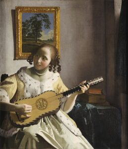 A woman in an ermine-lined coat playing a guitar.