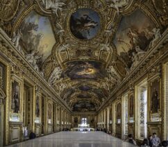 A large hall at the Louvre decorated with Baroque and Rococo decorative paintings.