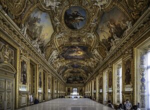 A large hall at the Louvre decorated with Baroque and Rococo decorative paintings.