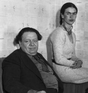 A black-and-white photograph of Diego Rivera and Frida Kahlo.