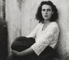 A black-and-white photograph of a young woman, Leonora Carrington