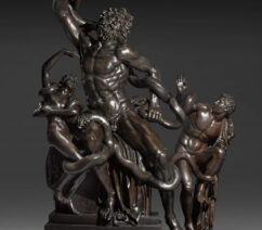 A bronze sculpture of three figures being strangled by snakes.