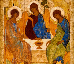 A medieval orthodox icon showing three angels sitting around a table.