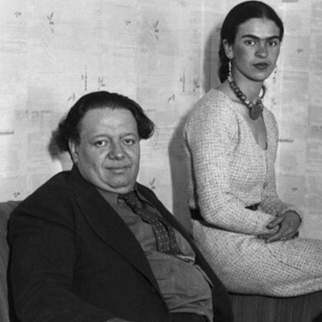 A black-and-white photograph of Diego Rivera and Frida Kahlo.