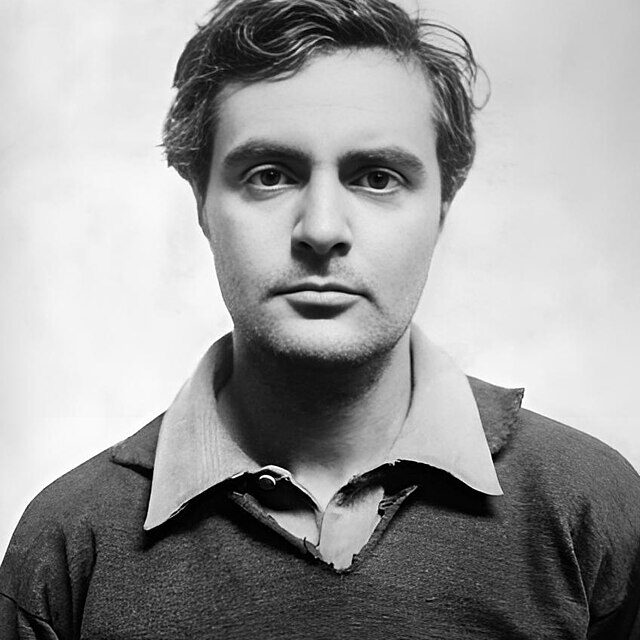 A black-and-white photographic portrait of a man, Amadeo Modigliani