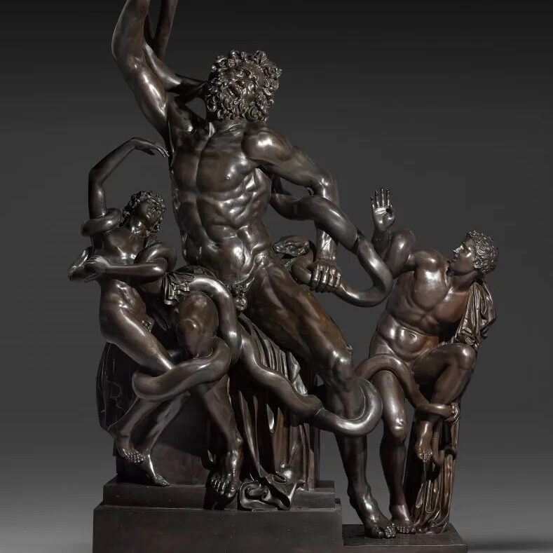 A bronze sculpture of three figures being strangled by snakes.